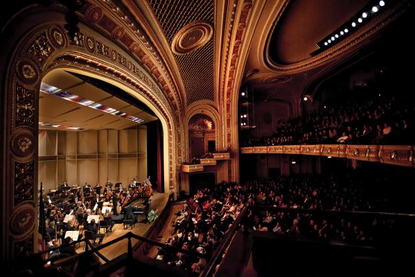 photo of symphony on stage and audience at the tivoli